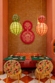 Dining chairs upholstered in Cactus Flower fabric by Christopher Farr Cloth, in vivid pink and orange. A vibrant hospitality interior designed by North 5 Consulting Group and Popus Editions, blending playful pattern with performance durability.